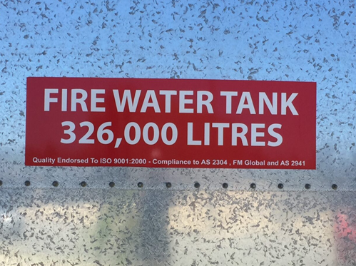 Sign on a fire water tank. Text reads: Fore water tank: 326,000 litres.
