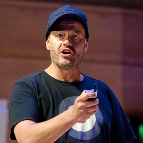 Photo of Adam Spencer wearing a black tshirt and a blue baseball cap